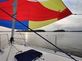 Colorful gennaker sail of a sailing yacht in the wind, sailing on the sea, calm evening weather