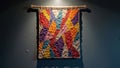 Colorful geometric crochet wall hanging on dark gray background Royalty Free Stock Photo