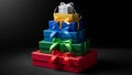 Of colorful gift boxes arranged in a pyramid shape against a Royalty Free Stock Photo