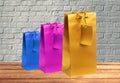 Colorful gift shopping bags on wooden table over brick wall Royalty Free Stock Photo