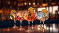 colorful gin tonic cocktails in glasses on bar counter in pup or restaurant