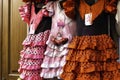 Colorful gipsy flamenco dresses on rack hanged in Spain market