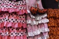 Colorful gipsy flamenco dresses on rack hanged in Spain market