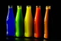 Colorful glass bottles on black background Royalty Free Stock Photo