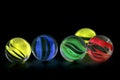 Colorful glass marbles on black background Royalty Free Stock Photo