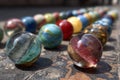 Colorful glass marbles displaying vibrant patterns, arranged in a row with selective focus on the foreground Royalty Free Stock Photo