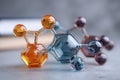 Colorful glass molecular structures representing chemical compounds with spherical atoms and hexagonal bases on a blurred Royalty Free Stock Photo