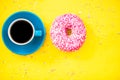 Colorful glazed donut and cup of coffee Royalty Free Stock Photo