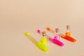 Colorful glitter in bottles and bright neon pens for writing on a natural background Royalty Free Stock Photo