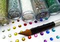 Colorful glitter and rhinestone crafts with brush