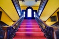 Colorful Staircase in Old Building with Wooden Railings