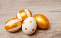 Colorful golden bright handmade painted easter eggs isolated on a wood