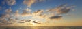 Colorful golden sunset above sea beach background. Evening atmosphere cloudscape skyline