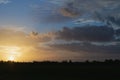 colorful golden sunset over meadows and forest. horizontal photo. scenery Royalty Free Stock Photo