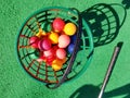 Colorful golf balls basket mini golf green Royalty Free Stock Photo