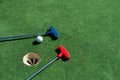 colorful golf putters with golf balls on synthetic grass Royalty Free Stock Photo