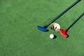 colorful golf putters with golf balls on synthetic grass Royalty Free Stock Photo