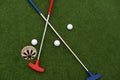colorful golf putters with golf balls on synthetic grass Royalty Free Stock Photo