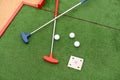 colorful golf putters with golf balls on synthetic grass Royalty Free Stock Photo