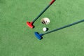 colorful golf putters with golf balls on synthetic grass Royalty Free Stock Photo