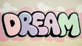 Colorful graffiti artwork featuring the word \'DREAM\' in playful bubble letters on a textured wall Royalty Free Stock Photo