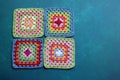 Rainbow colored Afghan squares on a table. Multicolored vintage ornament. Hippie fashion concept.
