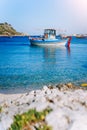 Colorful greek fishing boats at the calm clear water on early summer morning Royalty Free Stock Photo