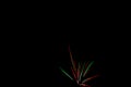 Colorful green, blue, white and red fireworks against black background, vivid color illustration Royalty Free Stock Photo