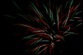 Colorful green, blue, white and red fireworks against black sky background, vivid color illustration Royalty Free Stock Photo