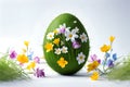 Colorful green easter egg decorated with flowers and green grass with spring flowers