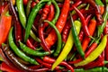 Colorful green, red and yellow chili peppers, natural background. Royalty Free Stock Photo