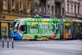 Colorful green, blue and yellow tram side view on main street in downtown area Zagreb