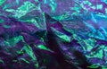 colorful grunge background. Rough texture. Neon light red green blue shiny wrinkled rock dark abstract art.