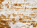 Colorful grunge texture of an old red brick wall with damage and peeling white paint Royalty Free Stock Photo