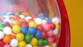 Colorful gumballs in classic vending machine, USA. Multi colored buble gums, coin operated retro dispenser. Chewing gum candies as
