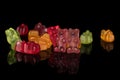 Colorful gummy bear isolated on black glass