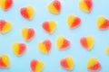 Colorful gummy candies pattern on blue background. Jelly sweets in shape of heart. Top view Royalty Free Stock Photo