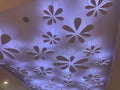 An Colorful Gypsum suspended false ceiling with flower design and indirect lighting for interior ceiling finishes for an shopping