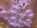 An Colorful Gypsum suspended false ceiling with flower design and indirect lighting for interior ceiling finishes for an shopping