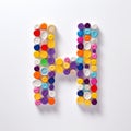 Colorful H Letter Sculpture With Plastic Capsules Royalty Free Stock Photo