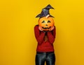 Woman holding sad jack-o-lantern pumpkin in front of face Royalty Free Stock Photo