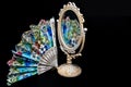 Colorful Hand Fan reflects in Vintage Oval Desk Mirror with white frame