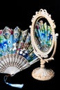 Colorful Hand Fan reflects in Vintage Oval Desk Mirror with white frame