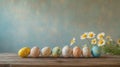 Colorful hand painted Easter eggs arranged on rustic wooden table with daisies Royalty Free Stock Photo