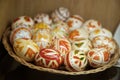 Colorful hand painted Easter Eggs in a wicker bowl. Egg decorating in Slavic culture