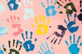 Colorful hand prints on pink wall Royalty Free Stock Photo