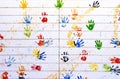 Colorful hand stamps on white wooden wall for use as background Royalty Free Stock Photo