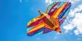 A colorful, handcrafted kite against a bright blue sky , concept of Artisanal craftsmanship, created with Generative AI
