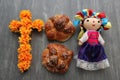 Colorful handmade cloth doll with pan de muerto from the town with sesame in the offering for the Day of the All Souls and All Sai
