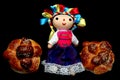 Colorful handmade cloth doll with pan de muerto from the town with sesame in the offering for the Day of the All Souls and All Sai